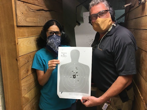 Claire and instructor David Williams, wearing masks because social distancing wasn’t possible on the range, showing the target after firing her personal Glock 19.