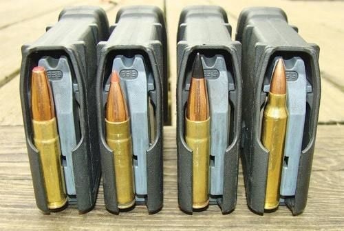 Three Blackout loads (L-R): Hornady 190-grain SUB-X, Hornady 110-grain V-MAX, and Barnes 110-grain TAC-TX. The solid-copper Barnes is topped by a long plastic tip designed to approximate 5.56/.223 cartridge length (R). Note their varying magazine-ribs engagements.