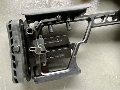 The folding stock pin has been stabliized for more security. It has multiple adjustment capabilities. When folded, it keeps the bolt from being opened. (Photo: Alan Clemons)